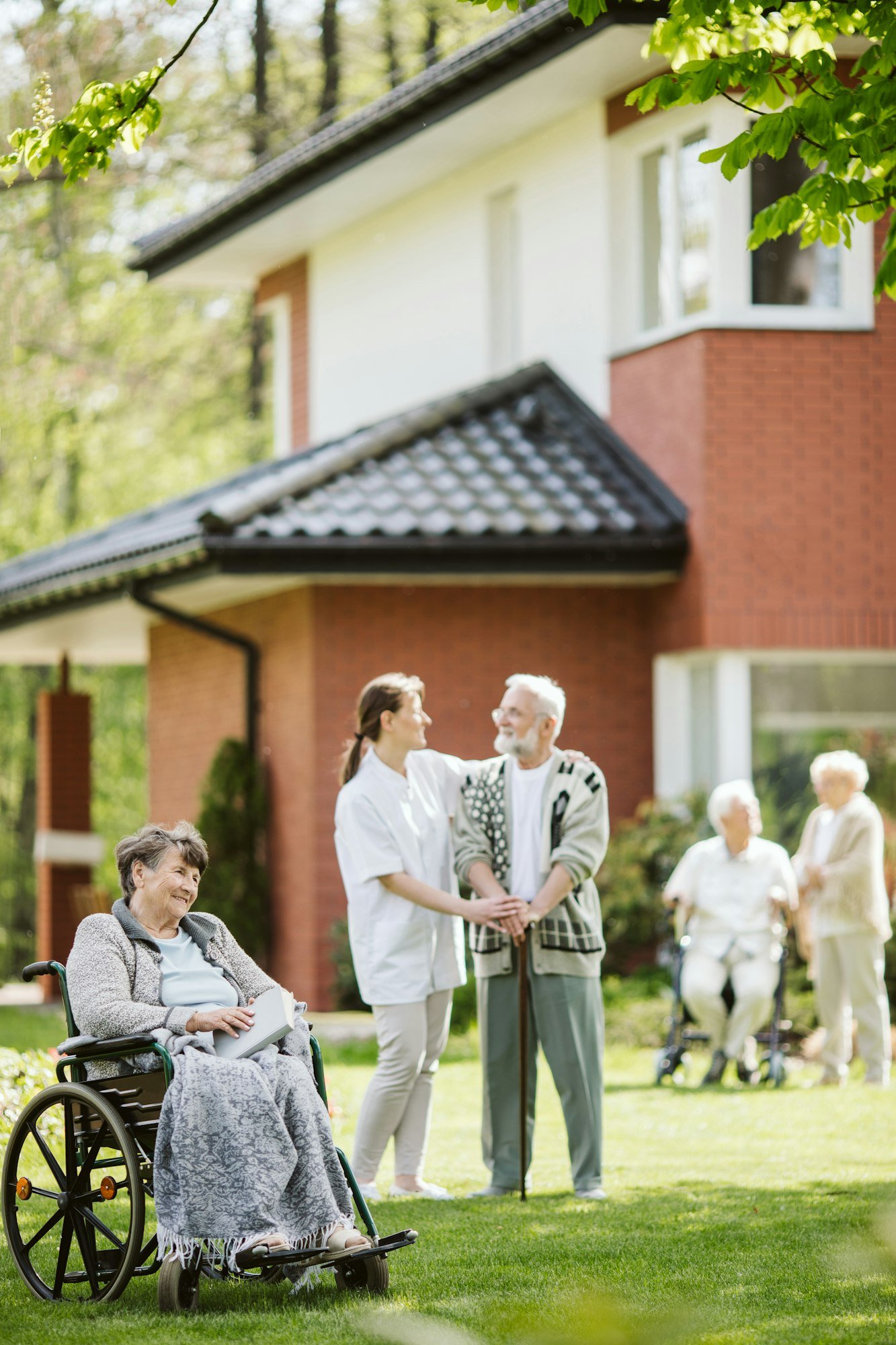 Happy group of elder people and caregiver in the garden